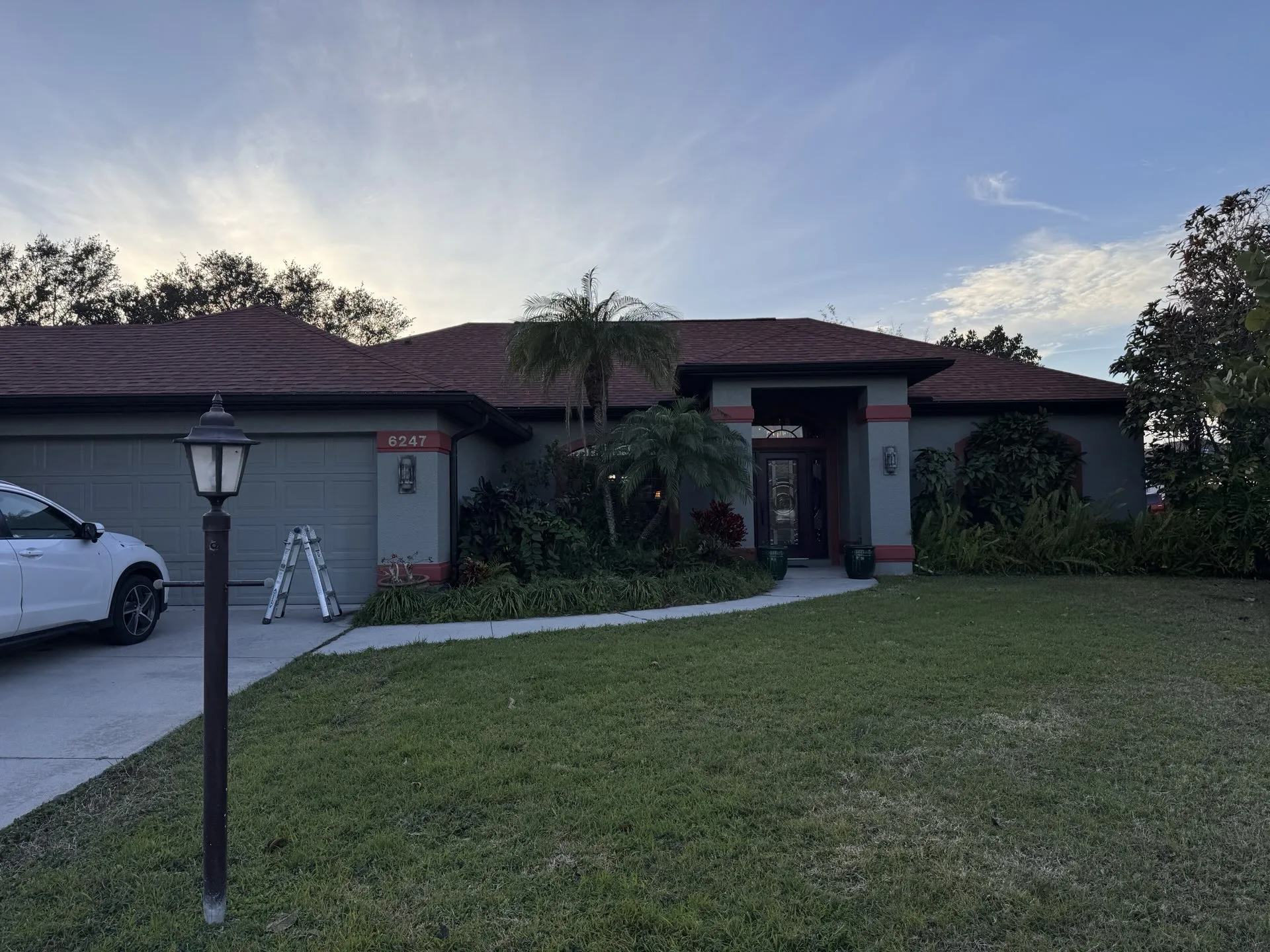 Barrier Builders roofing contractor step ladder set up for a free residential roof inspection on a Southwest Florida home.